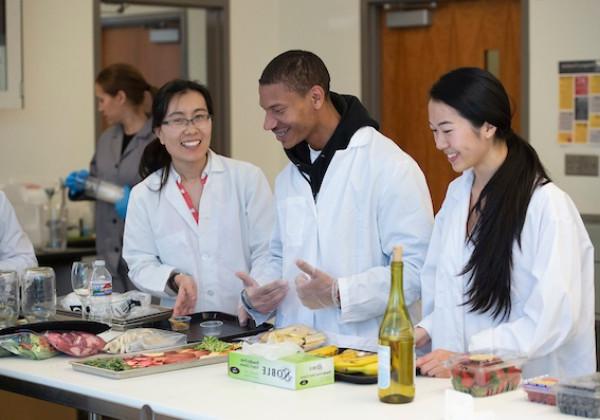 Professor and students working in a lab