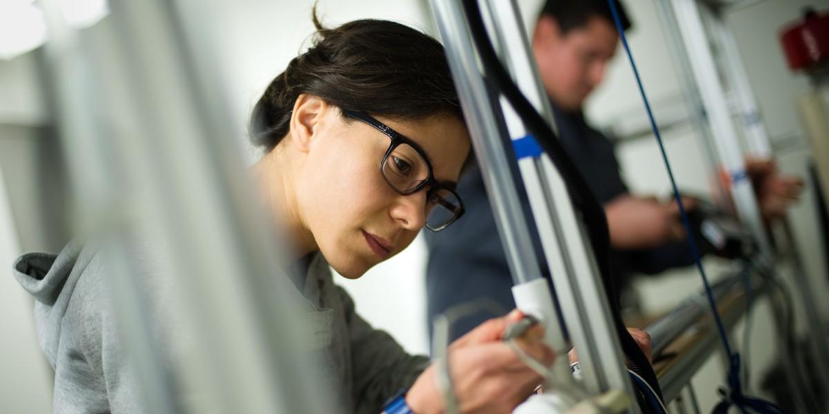 student using instrument on project in lab